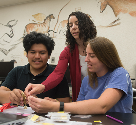 SIUE’s Carol Colaninno-Meeks (center) works with REU participants Alexander Huaylinos (left) and Hunter Ridley (right) as they identify 1,000-year-old fish remains using comparative materials in the SIUE Department of Anthropology Archaeology Lab.